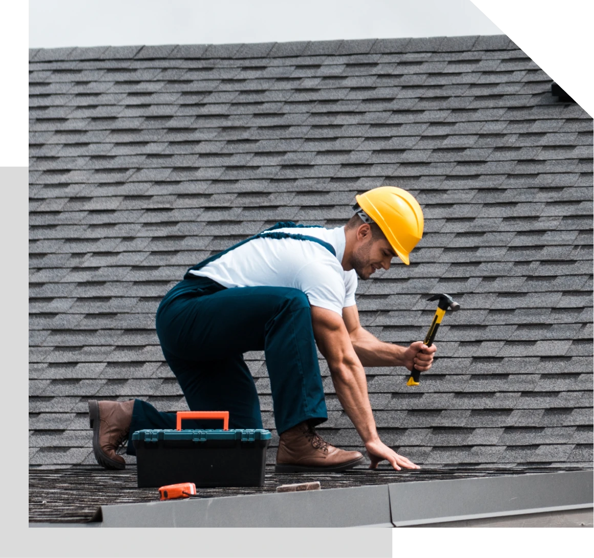 Construction worker repairing roof shingles